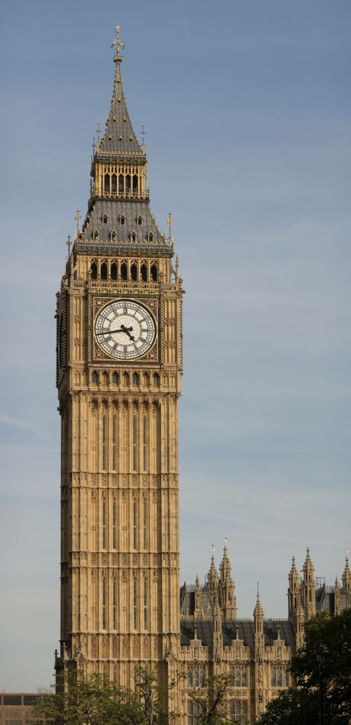 Big Ben clock tower in London with intricate Gothic architecture under clear blue sky wallpaper