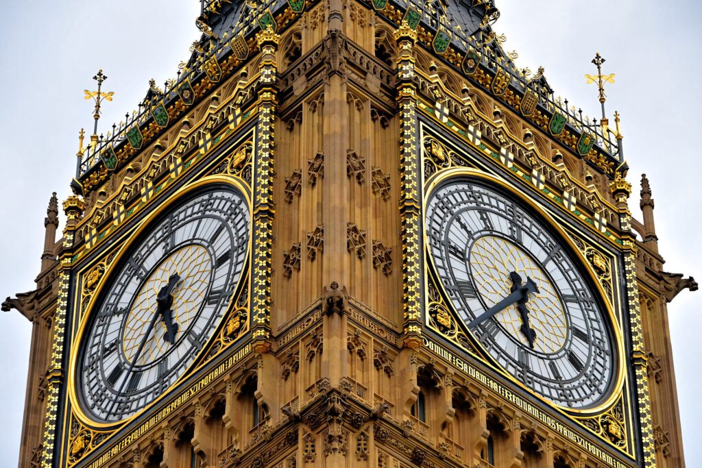 Close up angled view of Big Ben clock tower showcasing ornate details in London wallpaper background