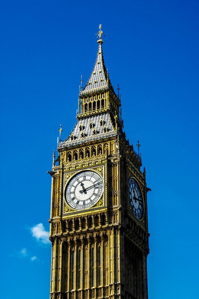 Close-up of Big Ben clock tower against blue sky showcasing detailed London landmark architecture Wallpaper
