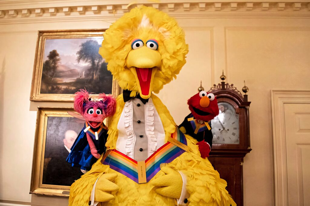 Big Bird Elmo and Abby in colorful formal outfits cheerful Sesame Street wallpaper background