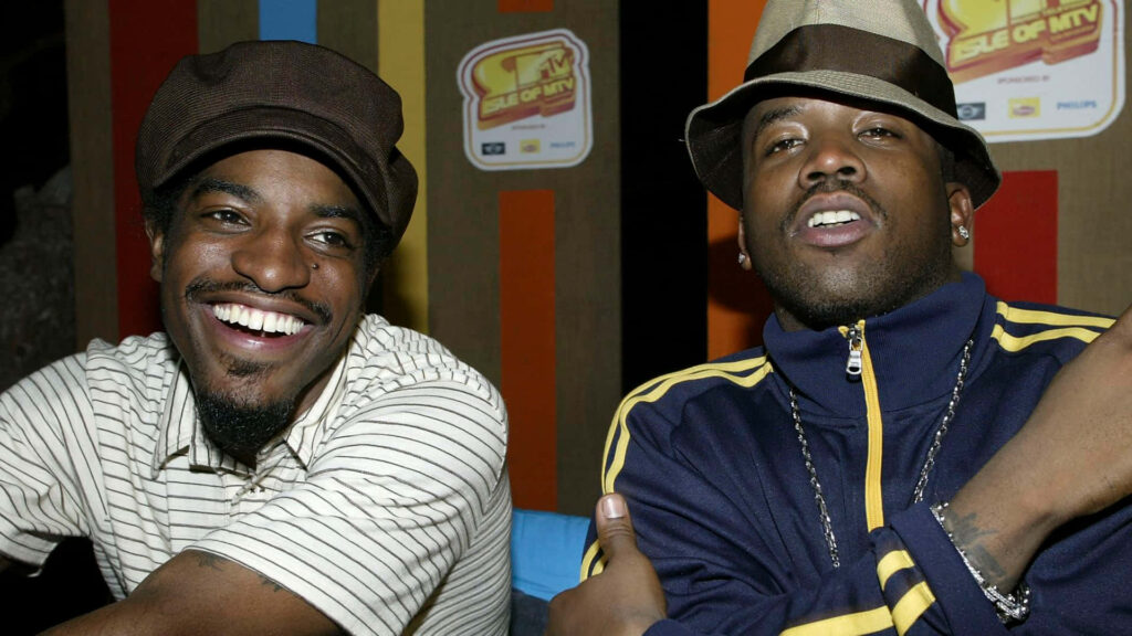 Big Boi and Andre3000 smiling together vibrant background hip hop duo friendship wallpaper