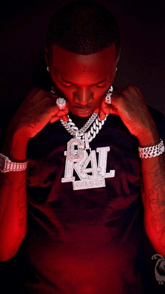 Big Boogie striking confident pose with bold jewelry under dramatic red lighting wallpaper background