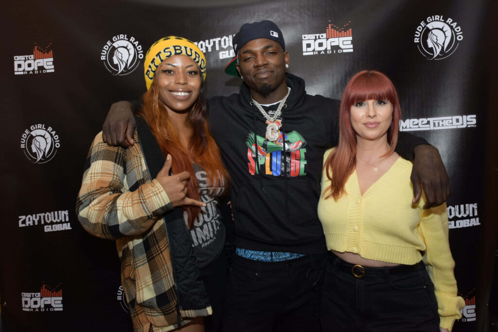 Big Boogie with fans at radio event vibrant backdrop energetic moment music promotion Wallpaper