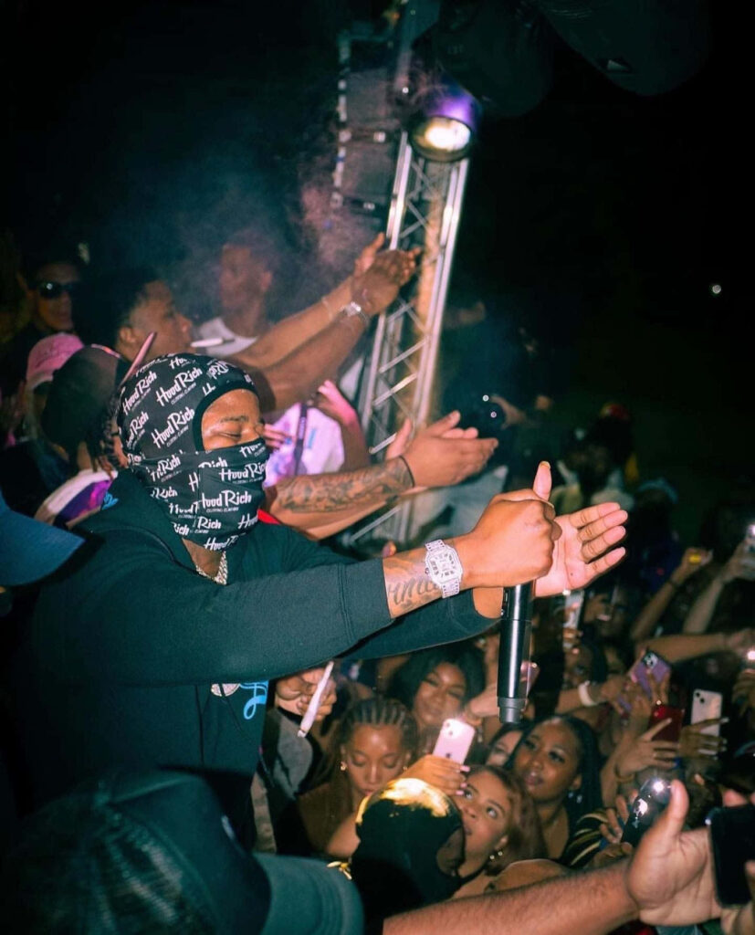 Big Scarr performing live on stage with energetic crowd capturing the moment on phones Wallpaper