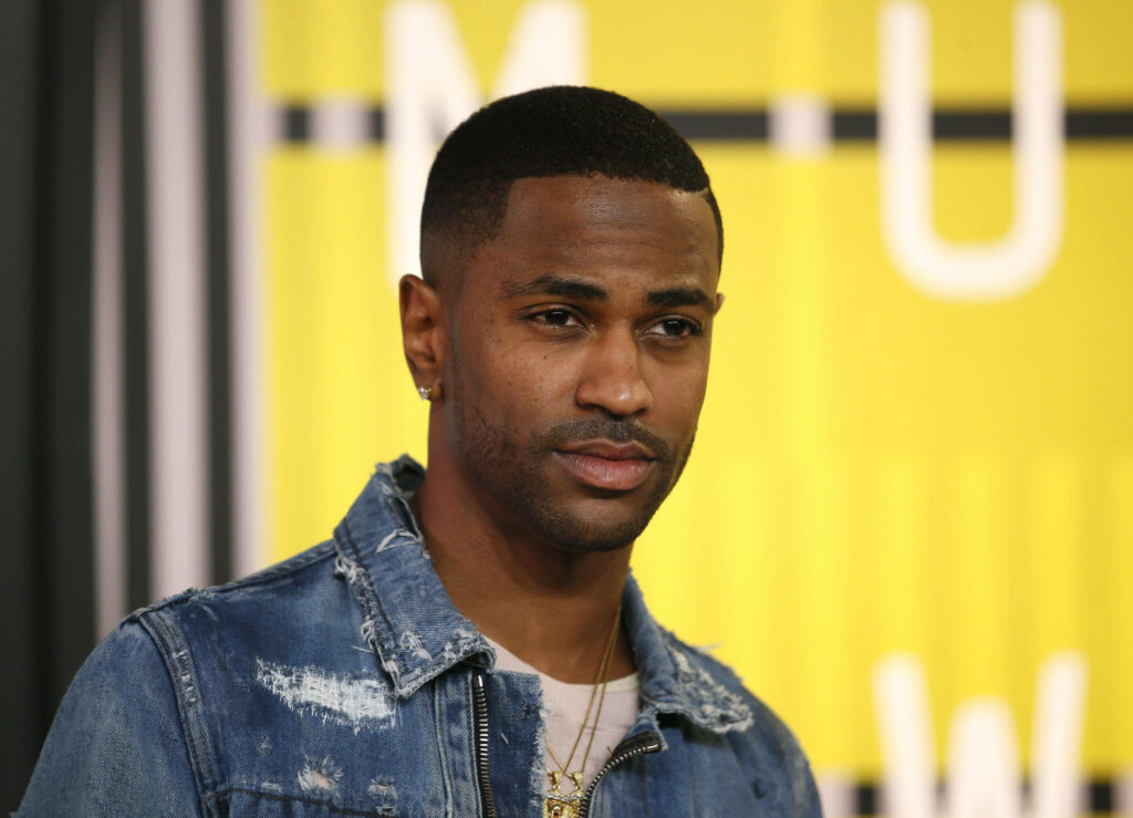 Big Sean candid in denim jacket at colorful event backdrop wallpaper background image