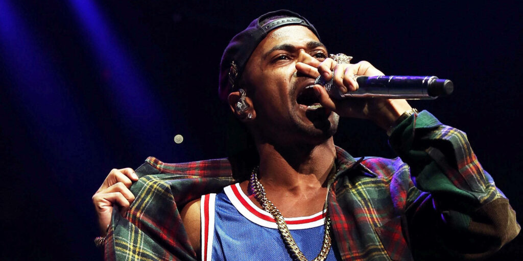 Big Sean performing live in plaid shirt and sports jersey capturing vibrant concert energy wallpaper