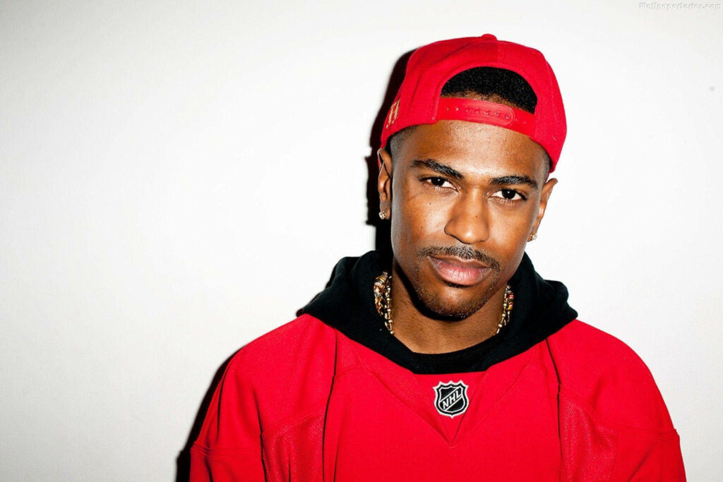Big Sean in bold red outfit and cap confident pose white background wallpaper image