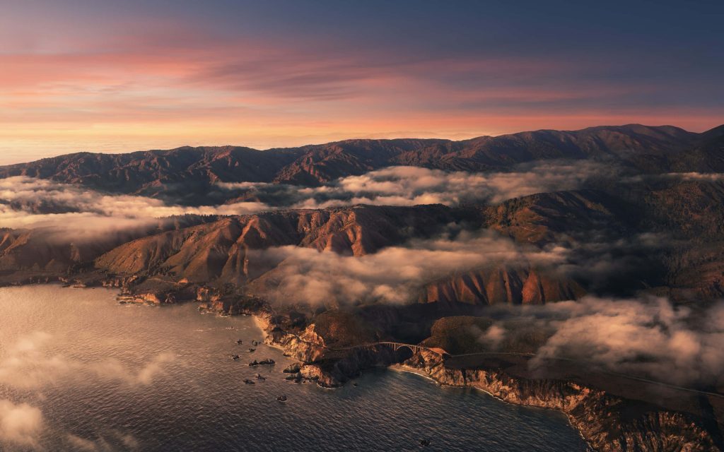 Aerial view of Bixby Creek Bridge at Big Sur California coastline during golden hour sunset Wallpaper