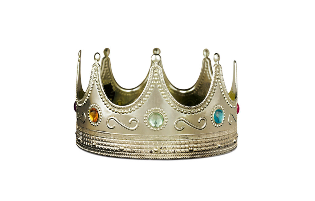 Golden jeweled plastic crown on white background iconic symbol of Biggie hip hop culture wallpaper