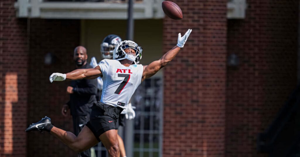 Bijan Robinson leaping catch football practice showcasing athleticism dynamic wallpaper background