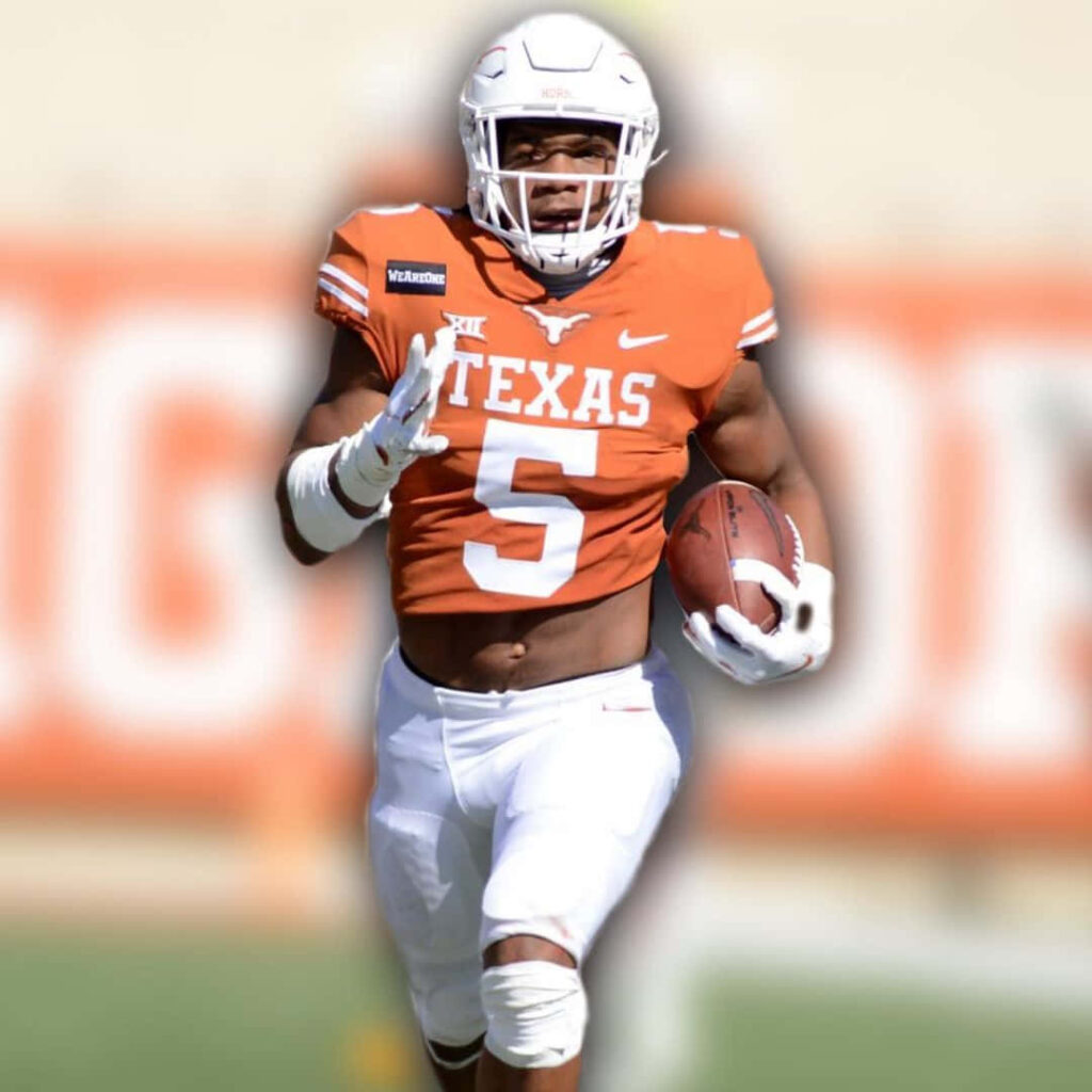 Bijan Robinson Texas Longhorns running back mid-play intense action football wallpaper background