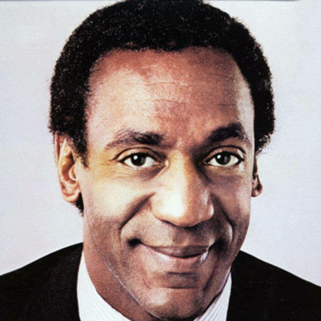 Close-up wallpaper of Bill Cosby with energetic smile and warm charismatic expression background