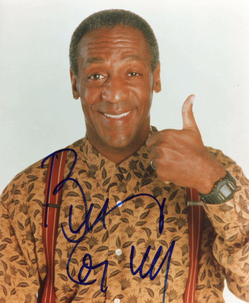 Bill Cosby smiling with thumbs up wearing patterned shirt and suspenders classic wallpaper background
