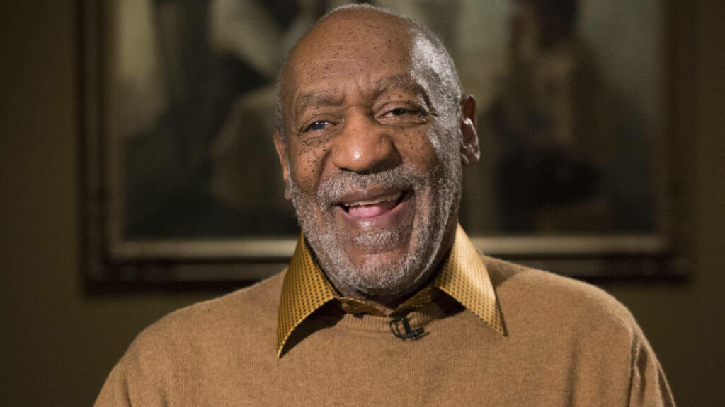 Bill Cosby smiling and laughing warmly creating a cheerful uplifting wallpaper background