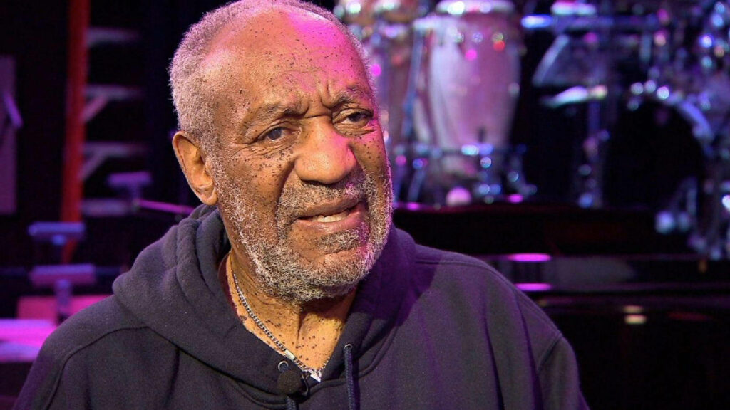 Bill Cosby worried expression with blurred musical instruments wallpaper background
