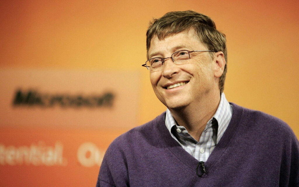 Bill Gates smiling warmly sharp focus inspiring professional orange blurred background wallpaper