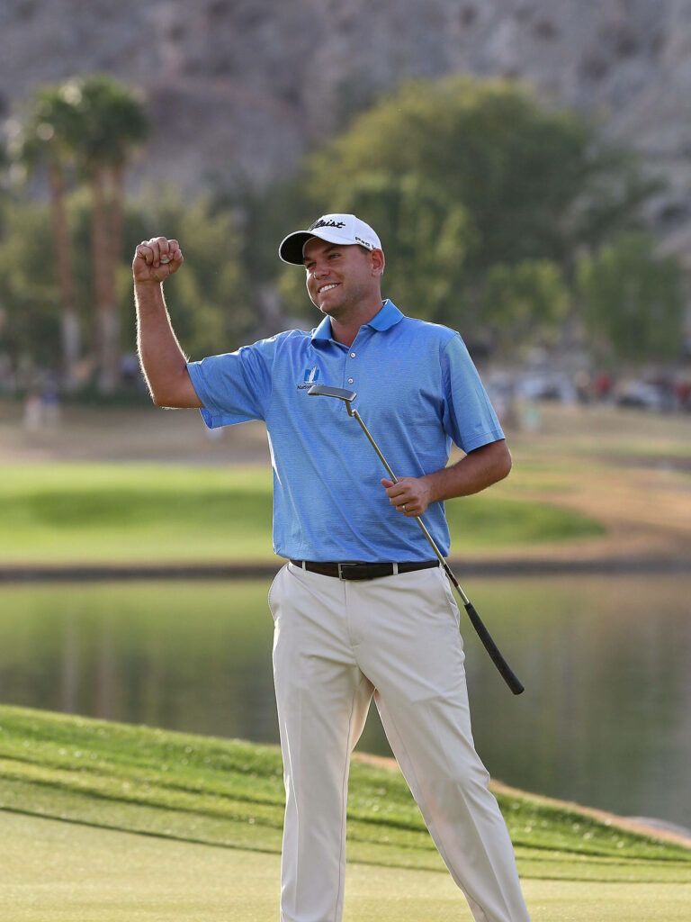 Bill Haas celebrating a golf victory on the course with raised fist and happy expression wallpaper