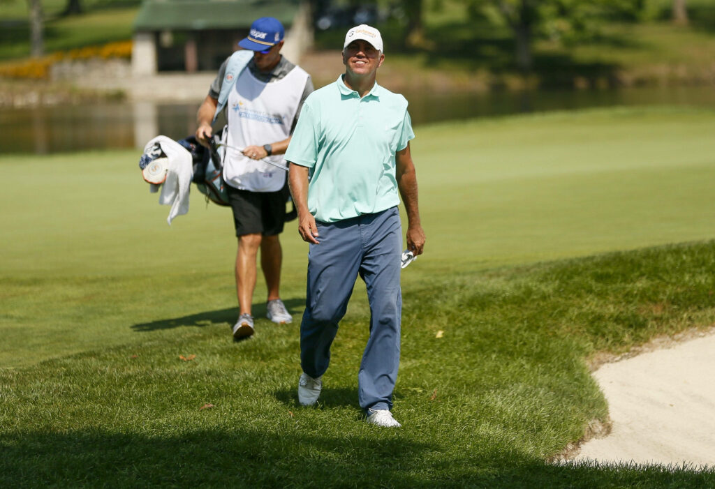 Bill Haas walking confidently on lush green golf course focused and composed golf wallpaper