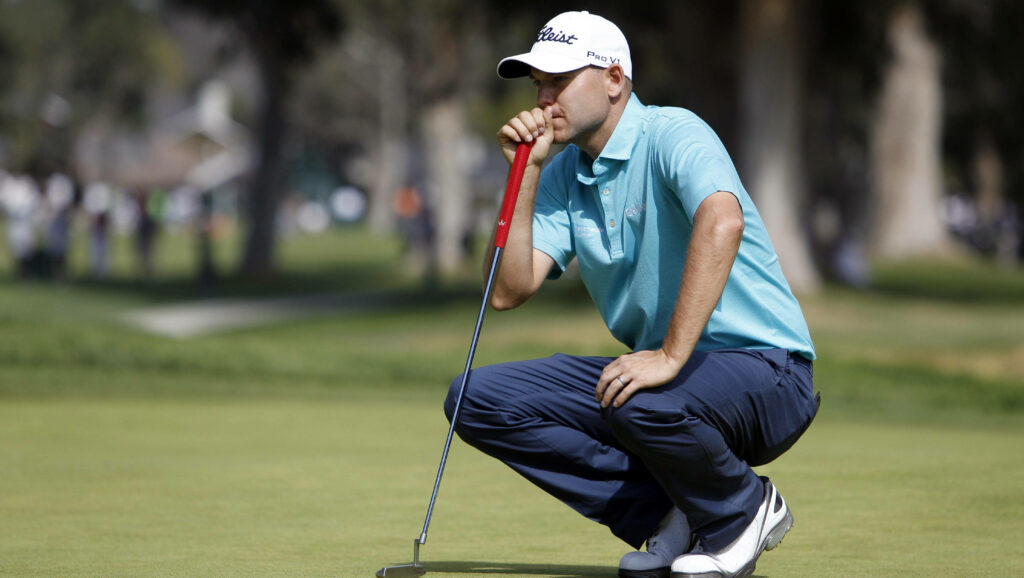 Bill Haas focused on green planning next golf shot during tournament wallpaper background