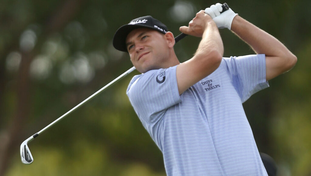 Bill Haas golfing in light gray shirt and cap swinging club outdoors blurred background wallpaper