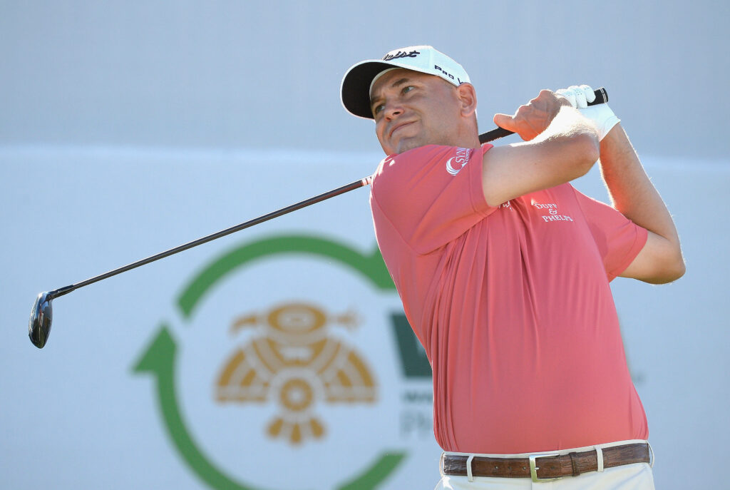 Bill Haas concentrating on golf swing during tournament marked by competitive return on course Wallpaper