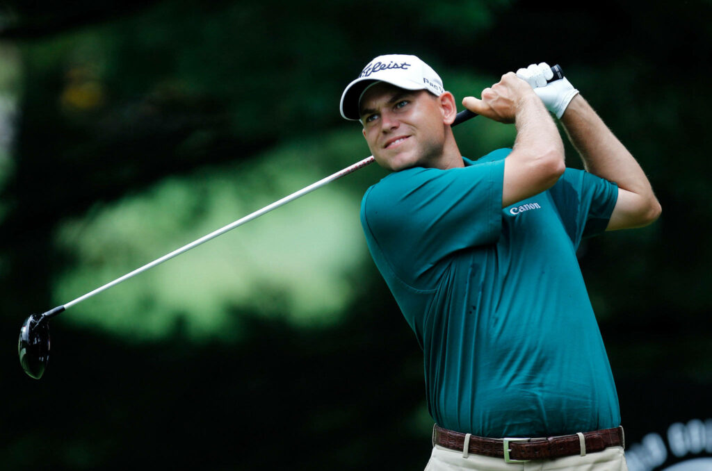 Bill Haas mid golf swing focused on course poised for perfect shot golf wallpaper background