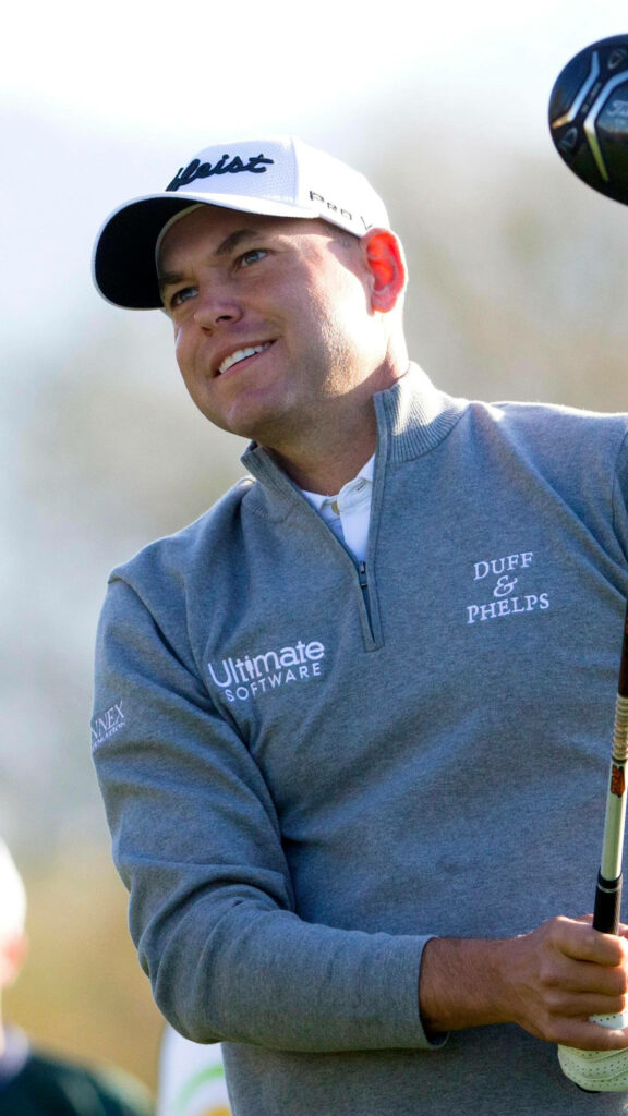 Bill Haas mid swing golf course wearing Duff Phelps Ultimate Software Sunex apparel wallpaper