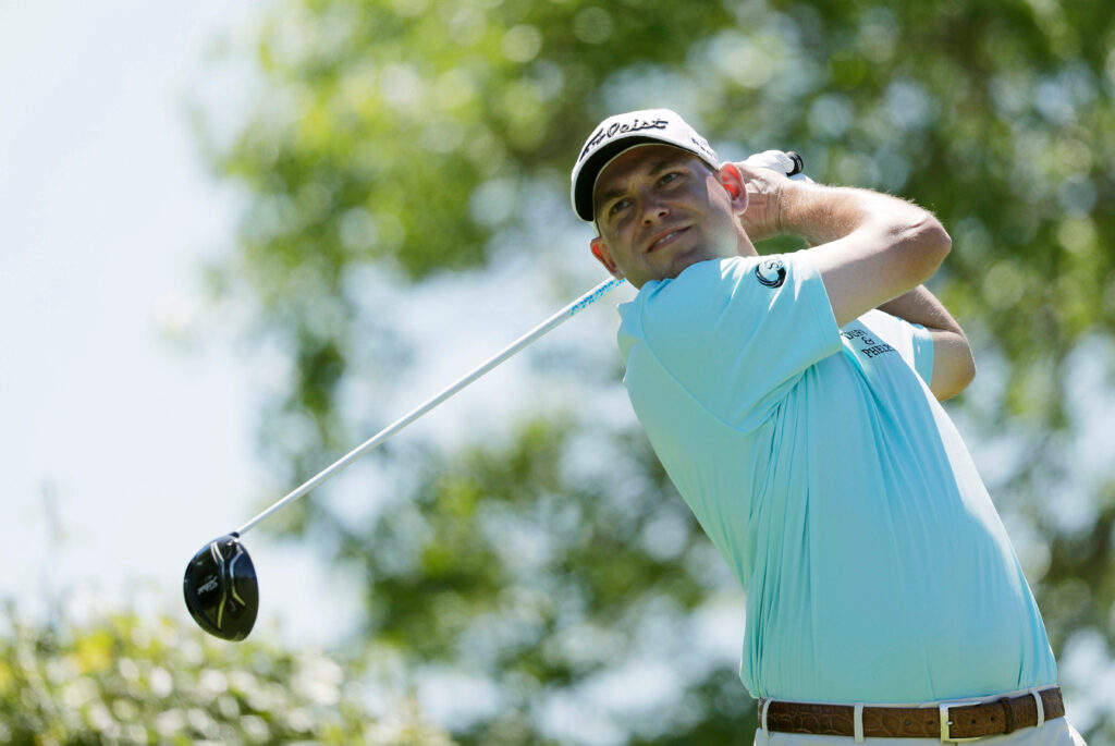 Bill Haas perfect golf swing on sunny course professional player focus wallpaper background