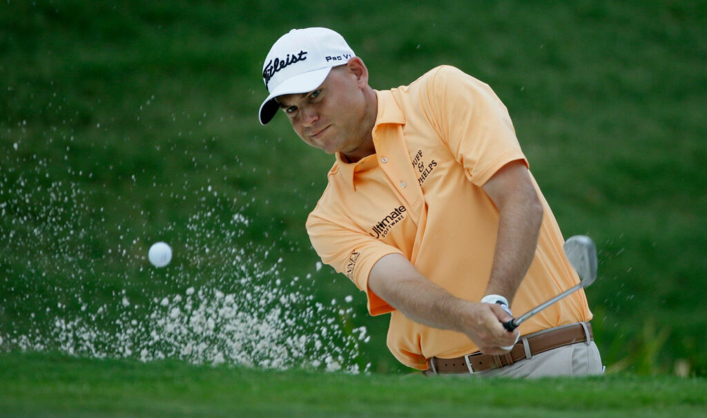 Bill Haas powerful swing from sand bunker showing focus and skill golf action wallpaper
