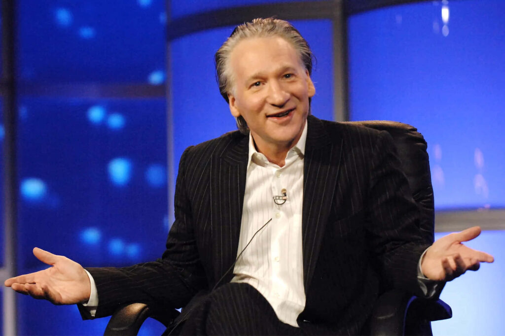 Bill Maher mid-conversation with relaxed expression in studio blue light background wallpaper