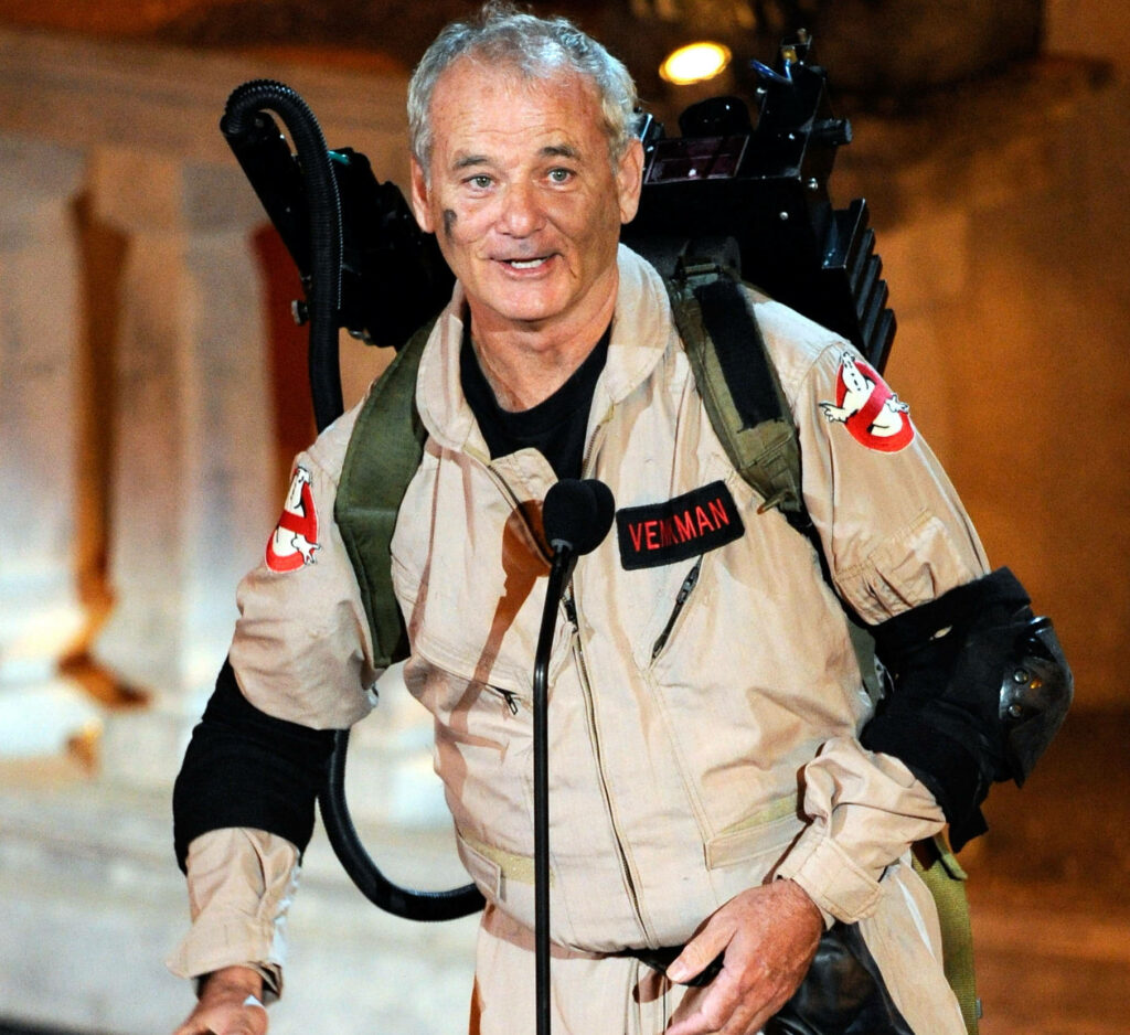 Bill Murray as Peter Venkman in Ghostbusters uniform holding proton pack iconic movie scene Wallpaper
