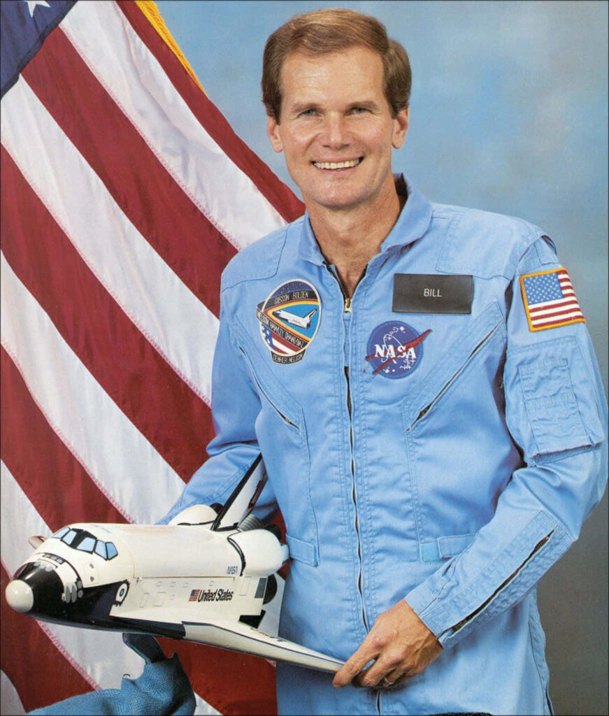 Bill Nelson in NASA Flight Suit with Space Shuttle Model - Wallpaper