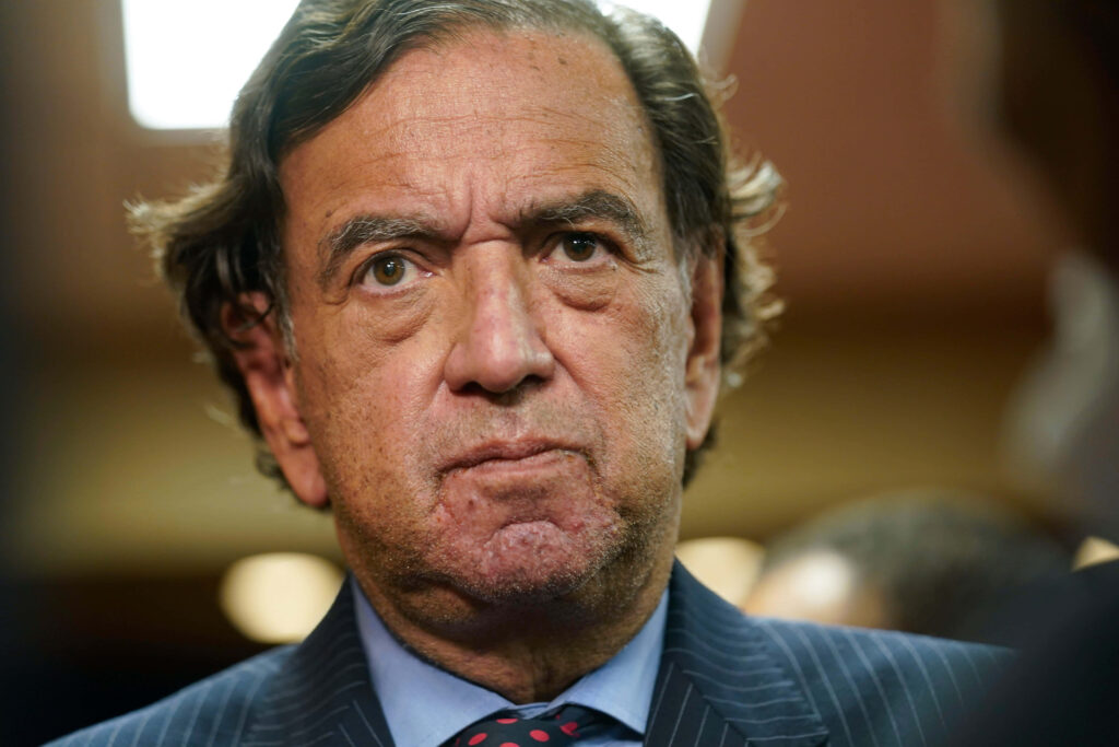Bill Richardson serious portrait in formal setting with wallpaper background thoughtful expression