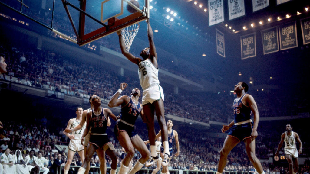 Bill Russell Celtics vs 76ers intense 1960s NBA game wallpaper with iconic green and blue uniforms