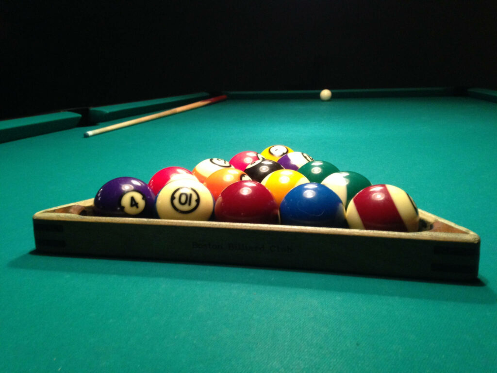 Billiards wallpaper showing neatly racked pool balls on green table ready for break shot