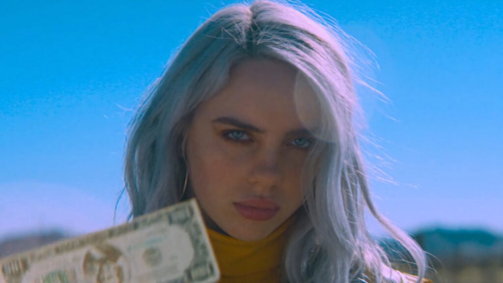 Billie Eilish Vibrant Wallpaper: Intense Style Against Bright Backdrop