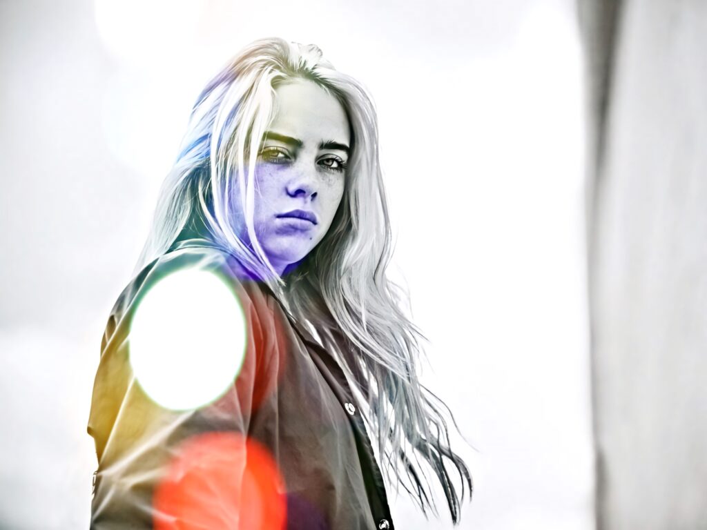 Billie Eilish Wallpaper: Intense Expression & Vibrant Light Flares