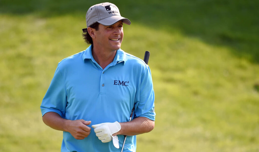 Billy Andrade smiling on golf course wearing blue EMC2 shirt and cap motivational wallpaper