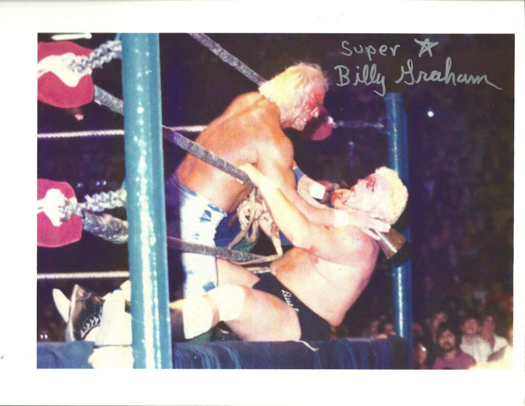 Billy Graham and Dusty Rhodes wrestling match wallpaper with Billy Graham autograph background