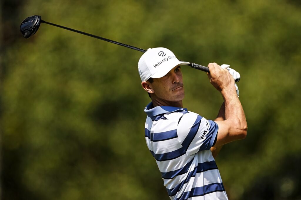 Billy Horschel golfing mid swing focused on lush green golf course dynamic wallpaper background