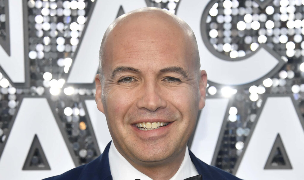 Billy Zane smiling confidently in glamorous sparkling background high quality wallpaper