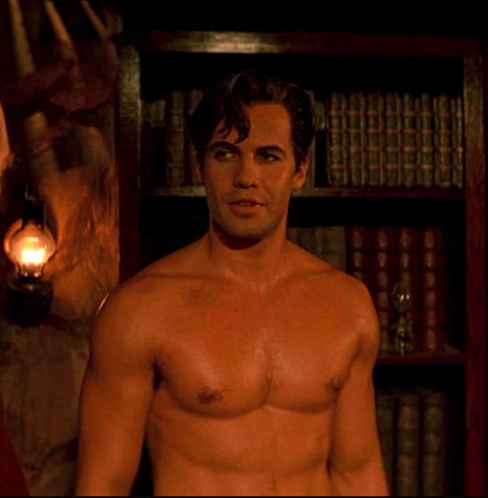 Billy Zane shirtless in warm light with classic bookshelf background wallpaper dramatic ambiance