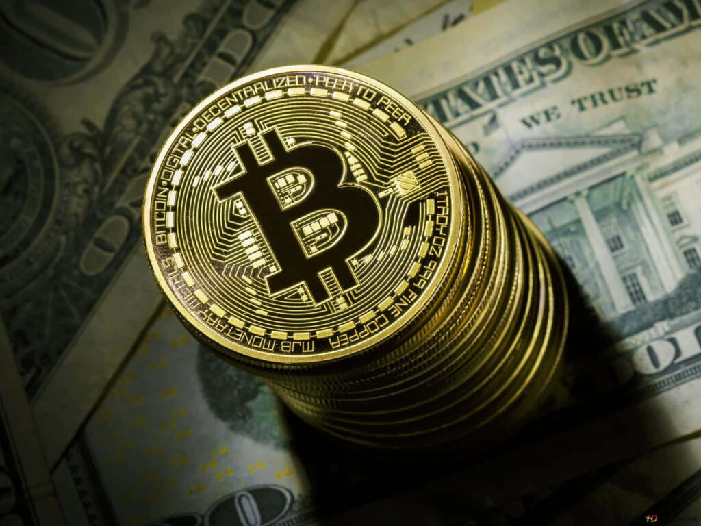 Stack of shiny Bitcoin coins on scattered US dollar bills representing crypto and traditional finance Wallpaper