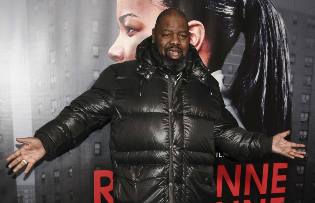 Biz Markie in black puffer jacket at event backdrop wallpaper for fans of his unique style