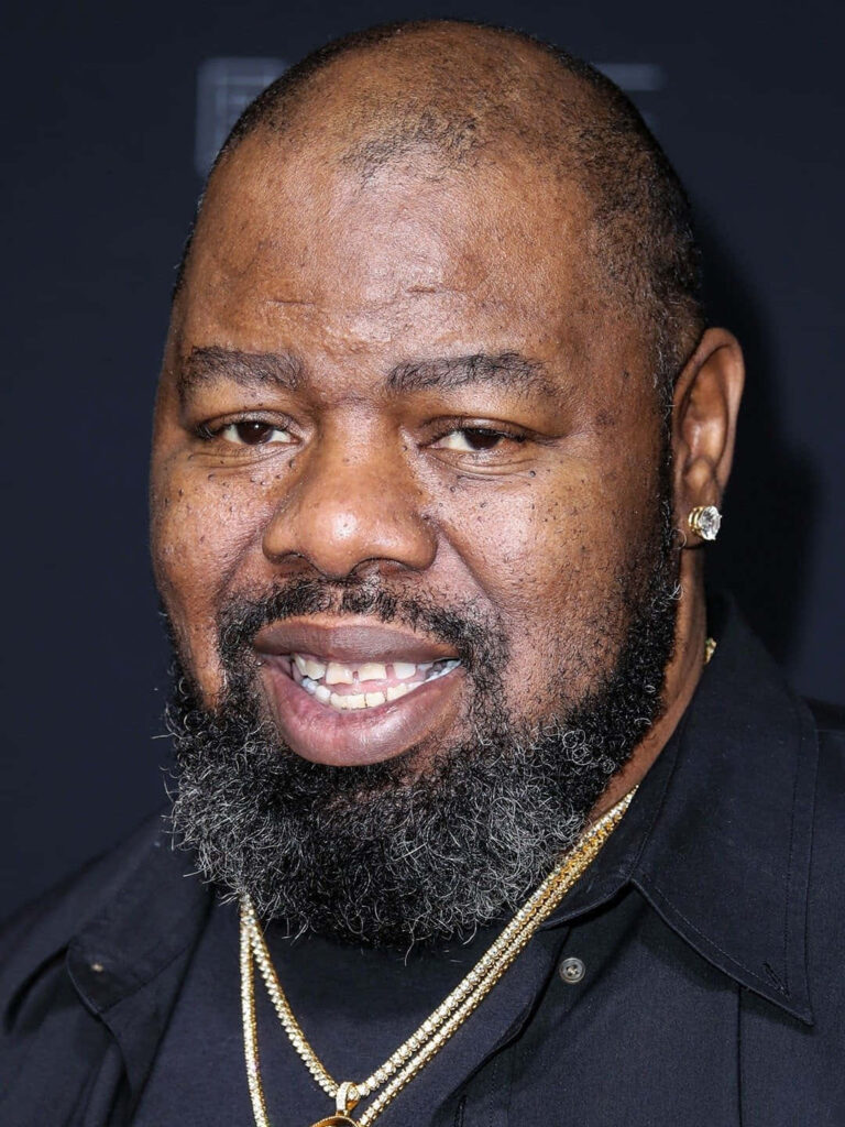 Closeup portrait of Biz Markie with friendly expression and signature style wallpaper background