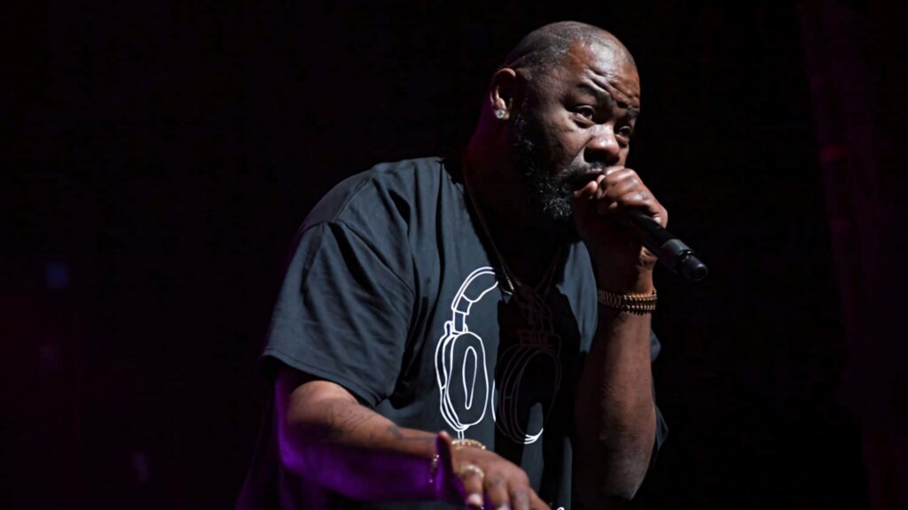 Biz Markie mid performance vibrant live wallpaper showcasing his energy and stage charisma