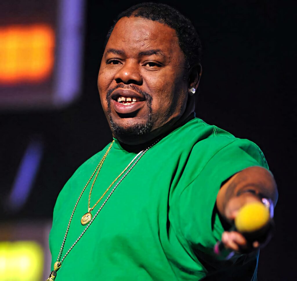 Biz Markie performing live on stage with vibrant colors showcasing his iconic style and energy Wallpaper
