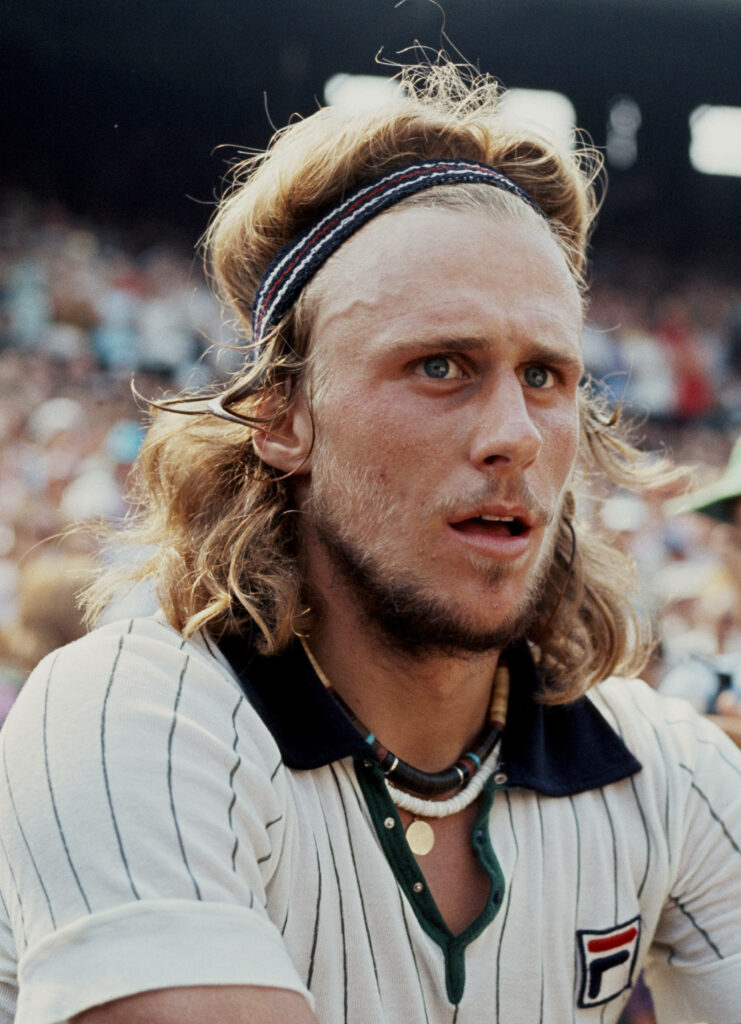Björn Borg intense tennis match wallpaper with signature headband and focused expression court crowd