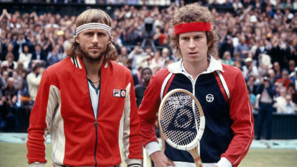 Bjorn Borg and John McEnroe on tennis court before singles match with packed crowd background Wallpaper