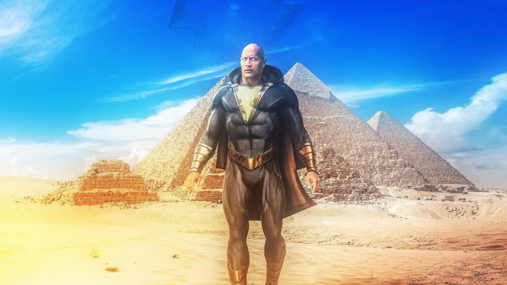 Dwayne Johnson as Black Adam standing heroically by ancient Egyptian pyramids under blue sky Wallpaper
